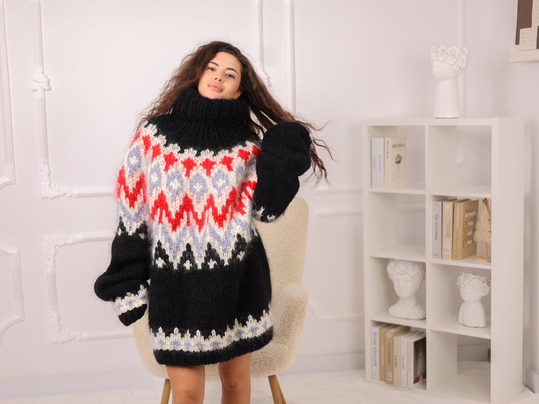 Woman wearing a patterned sweater and gloves in a room with a white bookshelf.