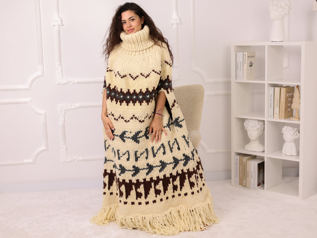 Woman wearing a long, patterned dress in a room with a white wall and bookshelf.