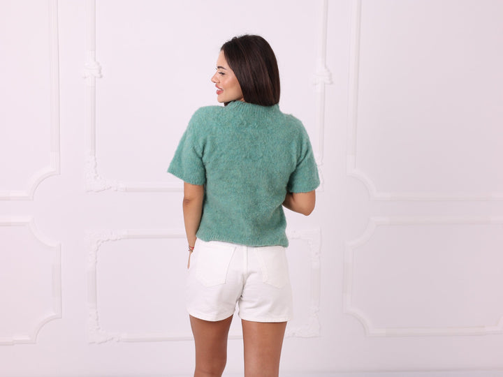Green yak blend sweater, back view with white shorts