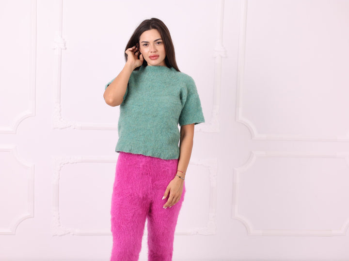 Green short-sleeve yak sweater styled with pink knit pants