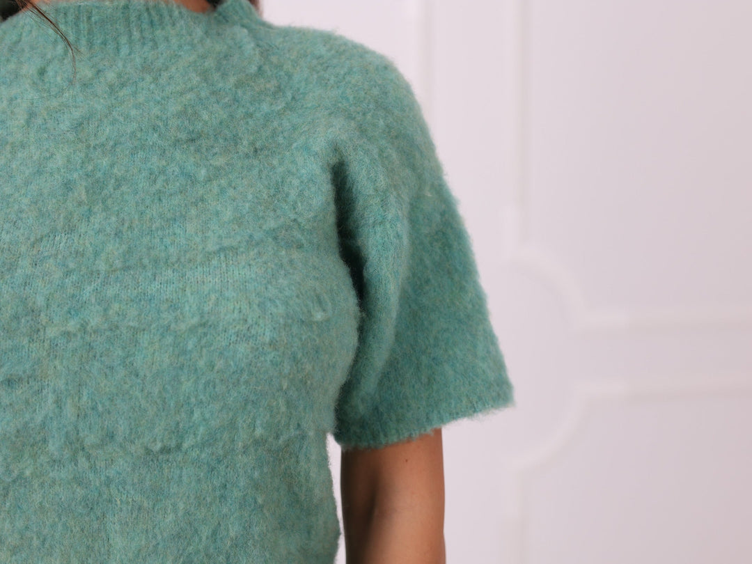 Close-up of soft green yak blend knit texture