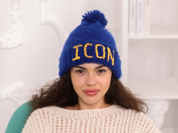 Close view of blue alpaca custom text beanie with pom pom