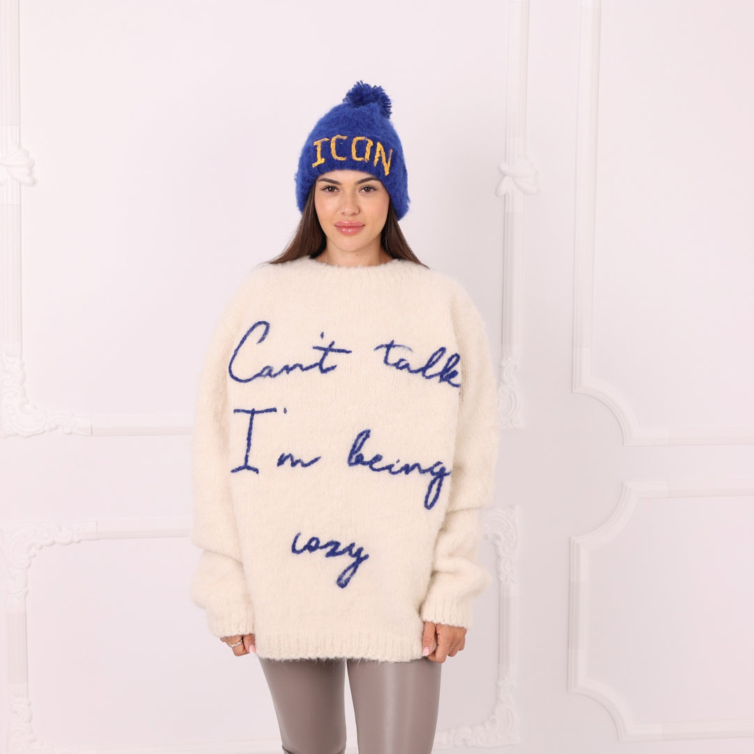 Blue alpaca personalized beanie with yellow ICON text worn by model