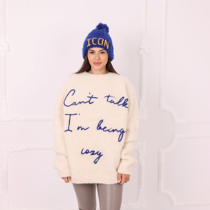 Blue alpaca personalized beanie with yellow ICON text worn by model