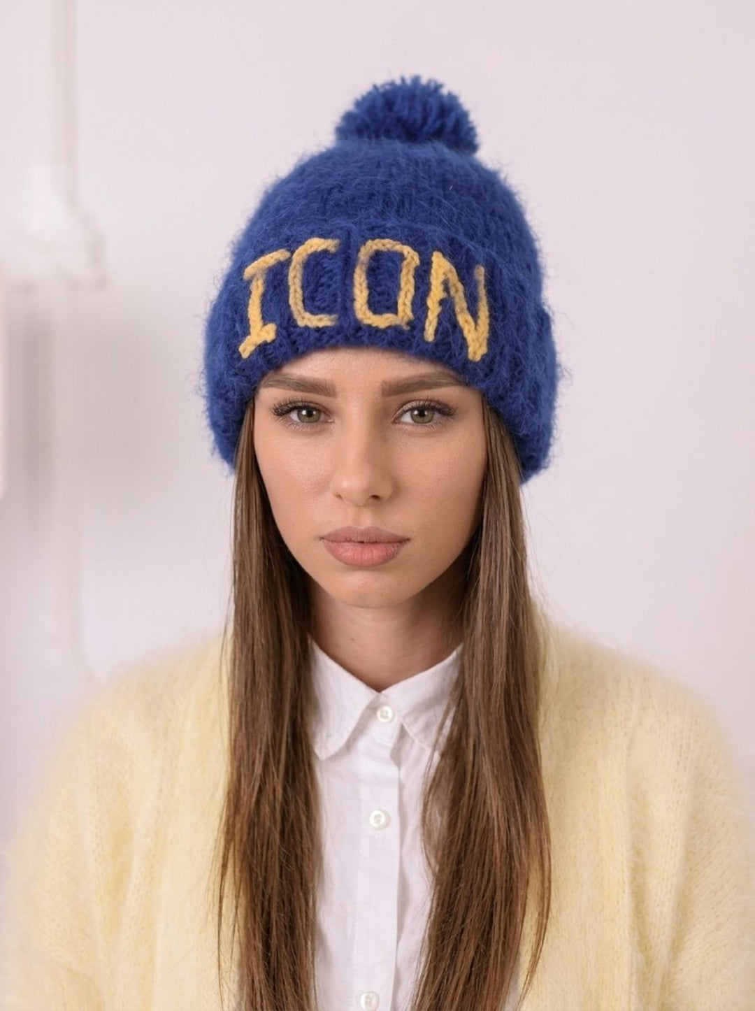 Portrait model wearing blue brushed alpaca personalized beanie