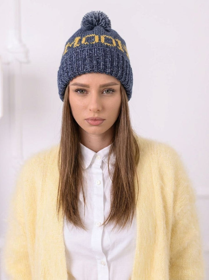 Model wearing personalized cotton wool beanie with pom pom and custom name