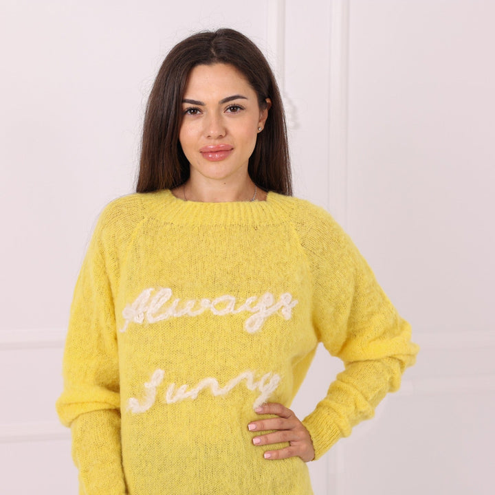 Hand knitted yellow baby alpaca sweater with custom white embroidery