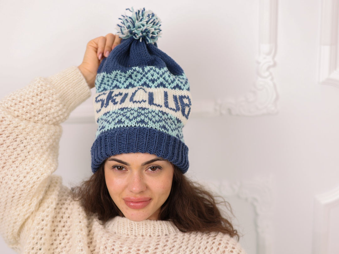 Model wearing blue and cream soft wool personalized SKI CLUB beanie