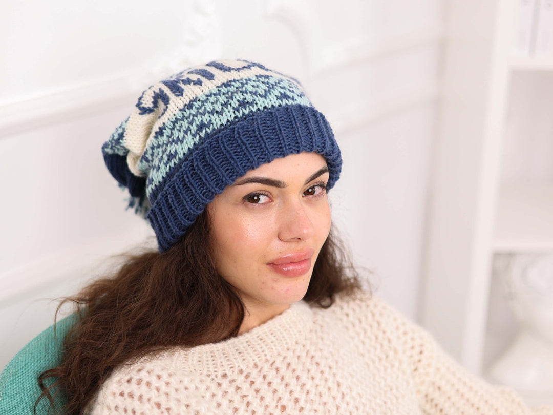 Side view of blue and cream soft wool SKI CLUB beanie with pom pom