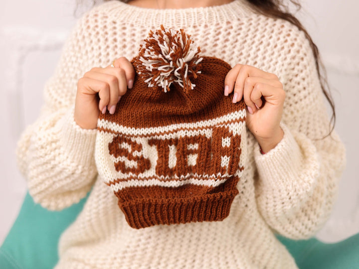 Hand held brown and cream soft wool beanie with STAR text and pom pom
