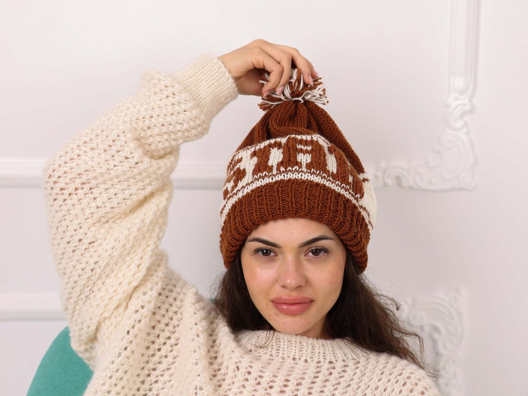 Model wearing soft wool brown and cream STAR beanie with pom pom