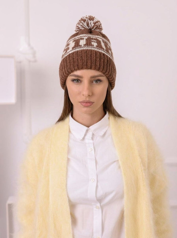 Studio portrait with brown and cream soft wool pom pom beanie