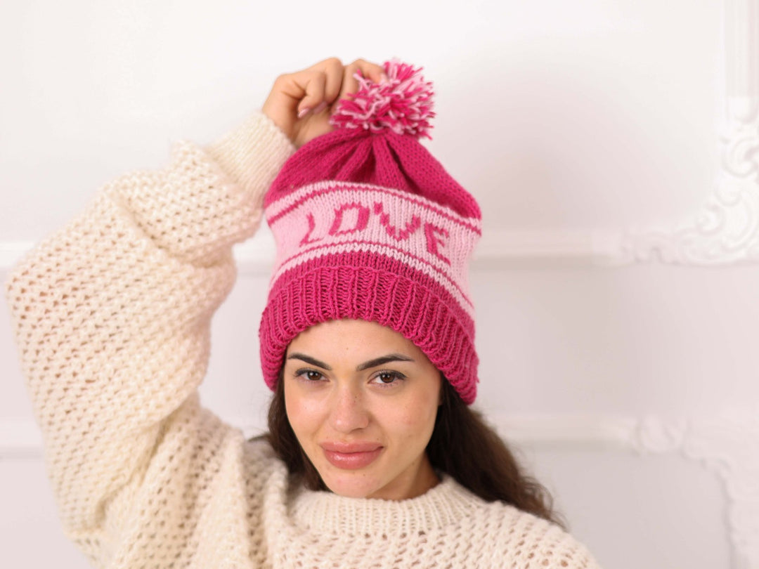Pink soft wool LOVE beanie with pom pom on model