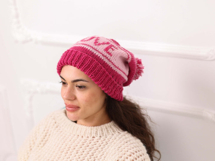 Side view of pink soft wool personalized LOVE knit beanie