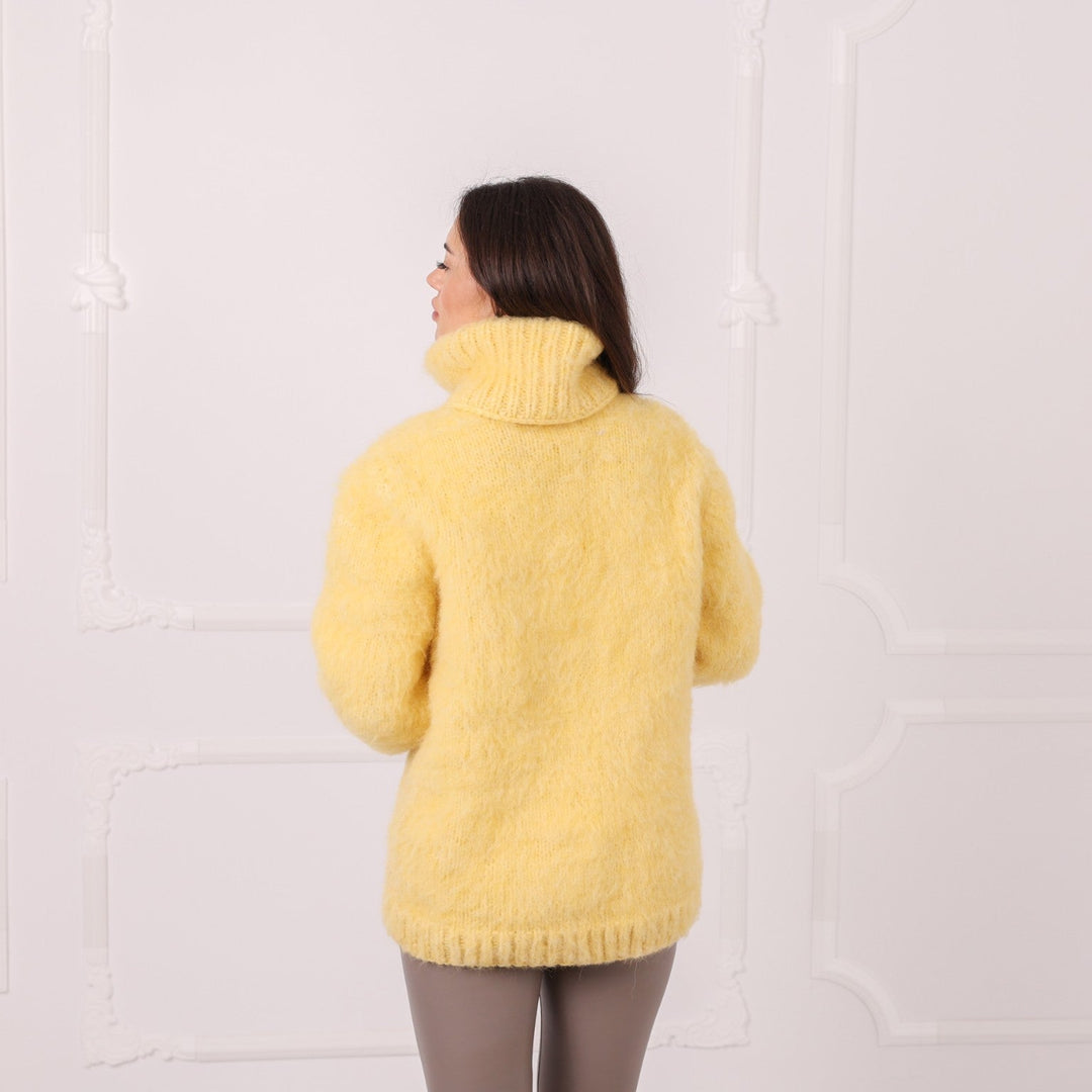 Back view of handmade yellow alpaca oversized sweater with high neck