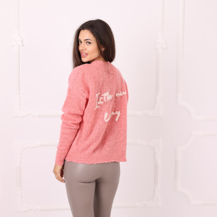 Side back view of pink baby alpaca personalized sweater with back phrase