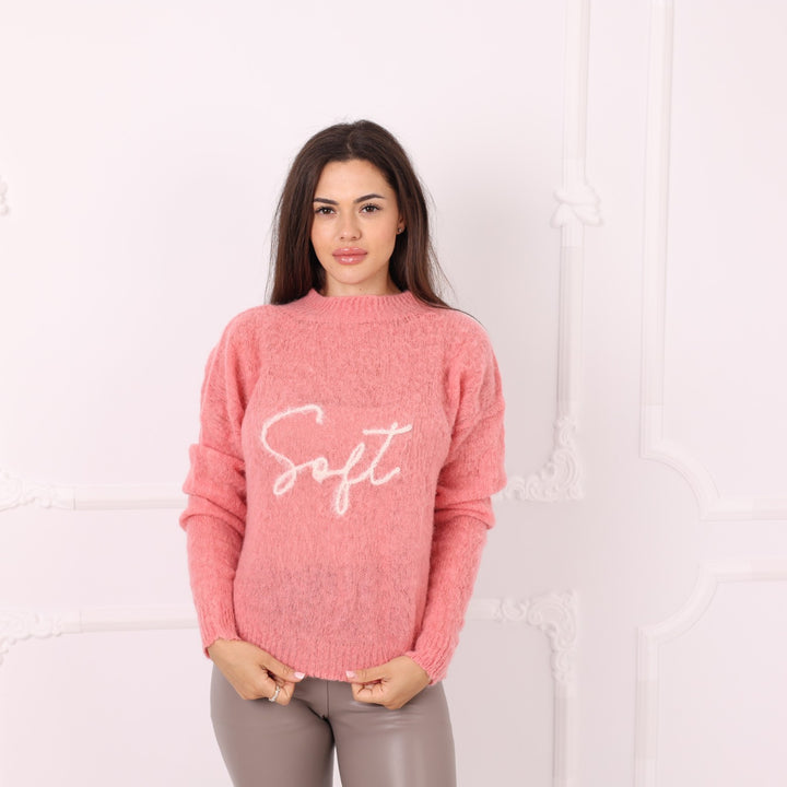 Model wearing pink baby alpaca personalized knit pullover with front embroidery