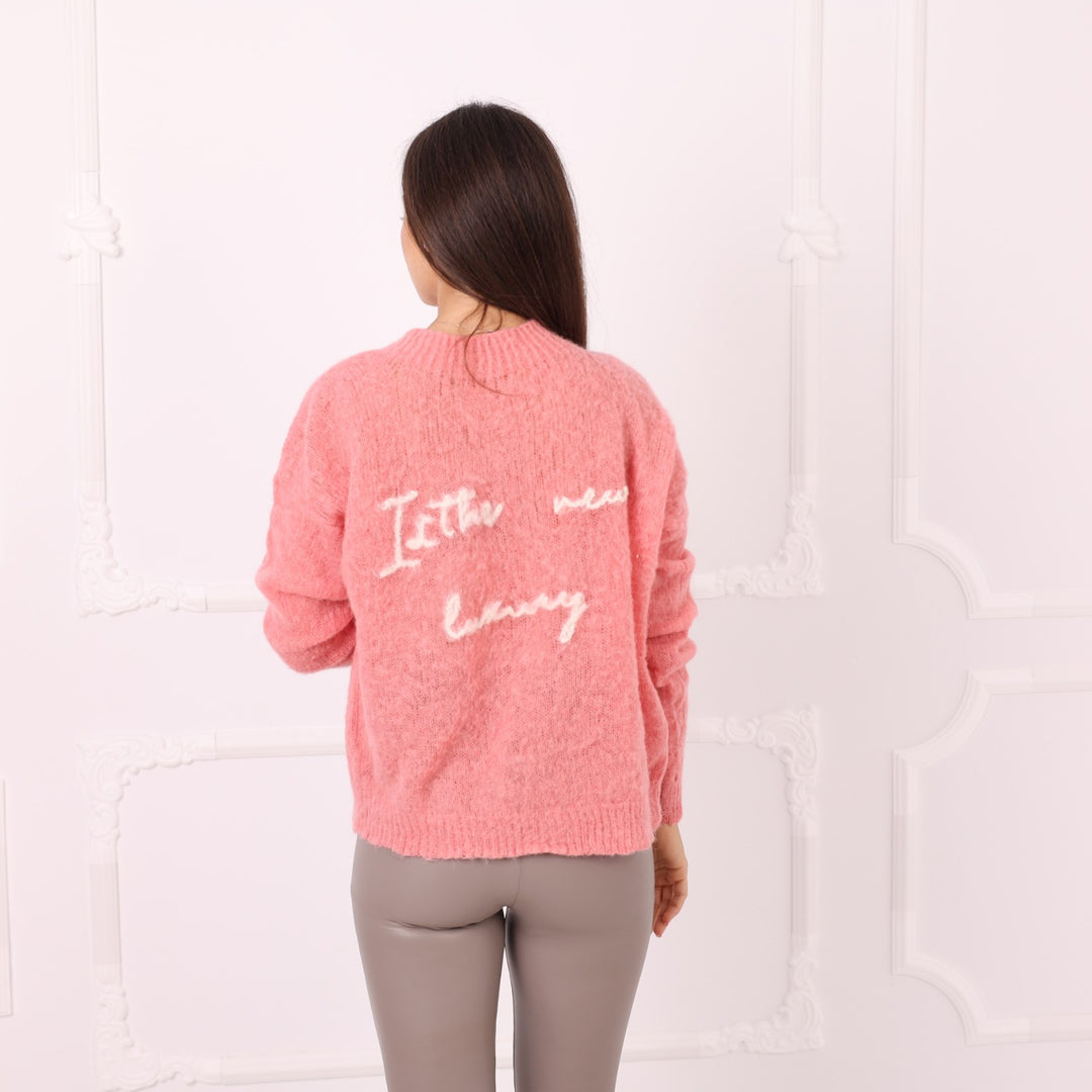 Back view of pink baby alpaca sweater with personalized phrase embroidery