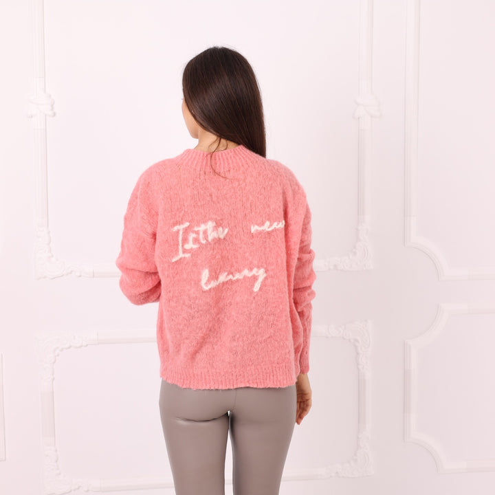 Back view of pink baby alpaca sweater with personalized phrase embroidery