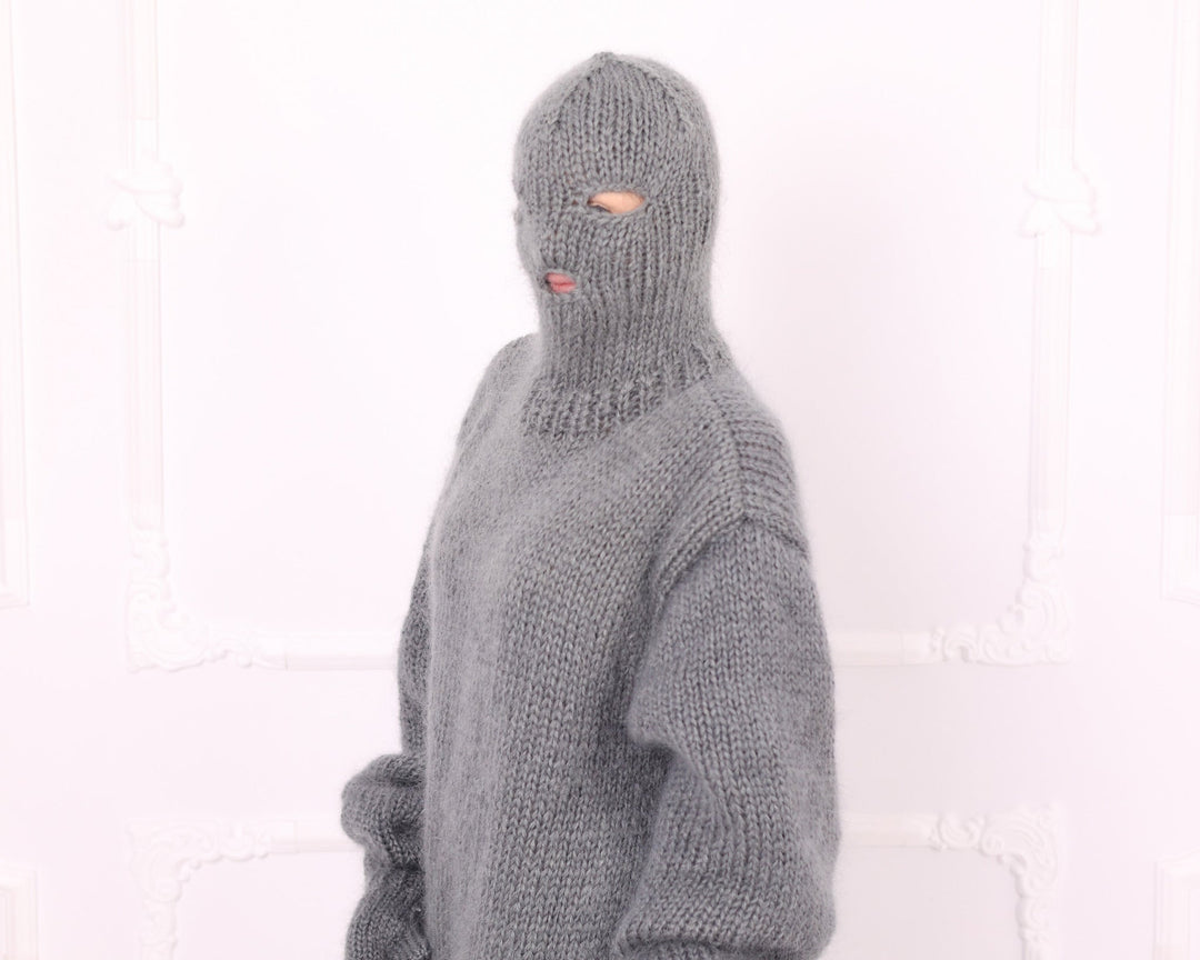 Gray knitted mohair balaclava hood close-up on oversized catsuit