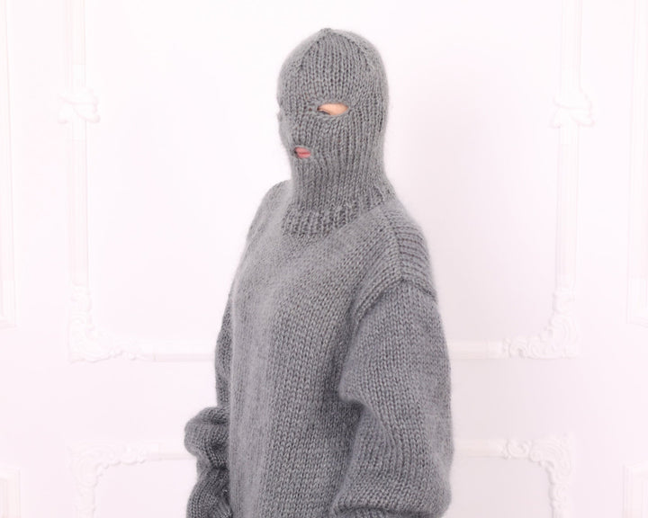 Gray knitted mohair balaclava hood close-up on oversized catsuit