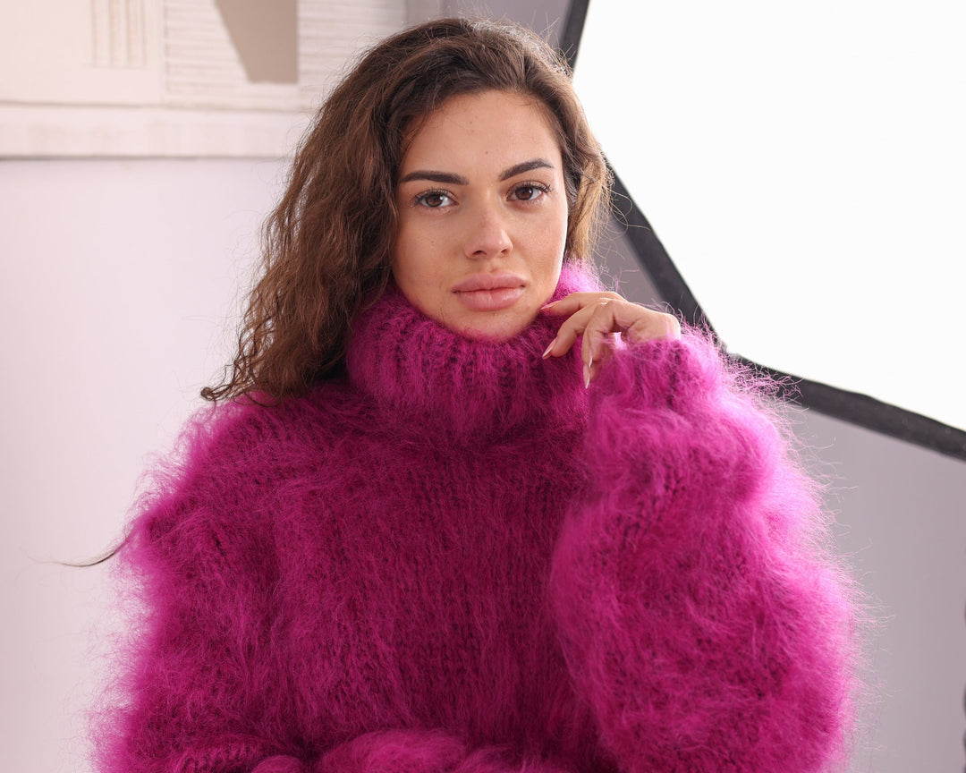 Pink mohair turtleneck sweater close-up studio detail