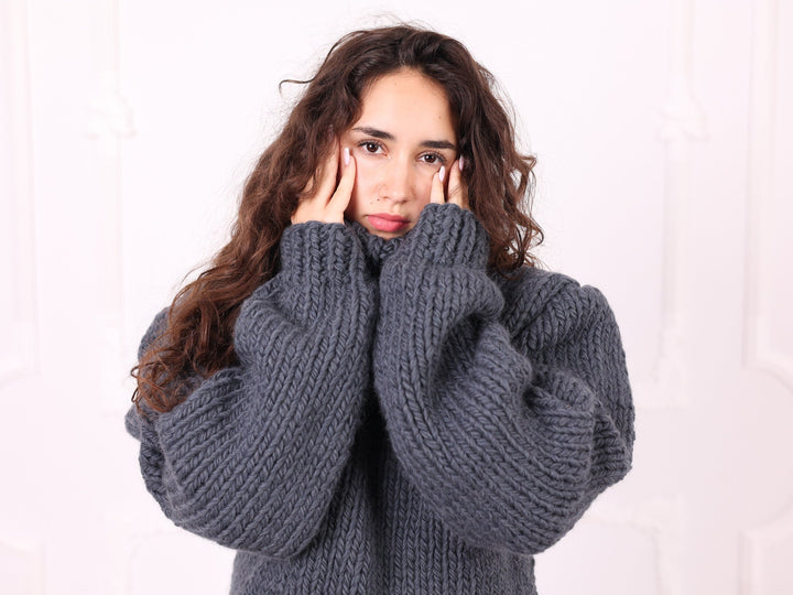Gray chunky wool turtleneck sweater sleeve and collar detail