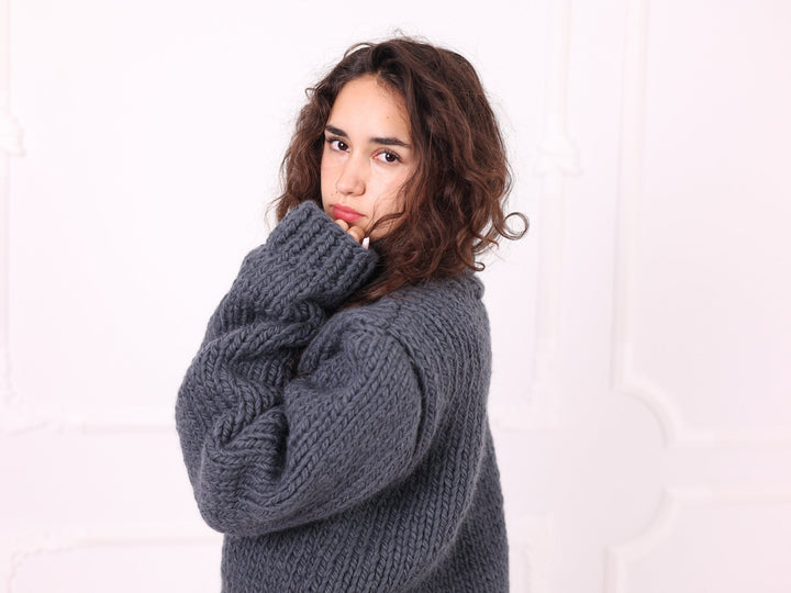 Gray hand knit wool turtleneck sweater portrait detail
